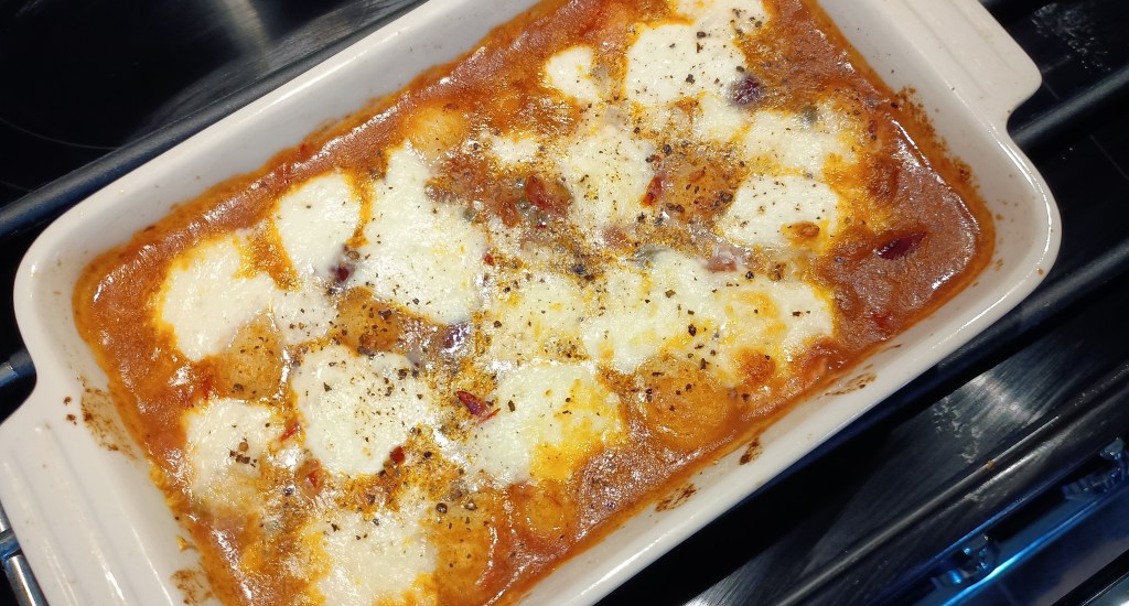 Puttanesca gnocchi, baked, Mozzarella tomatoes, molten, oven proof dish.